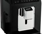 a black coffee machine sitting on top of a white surface