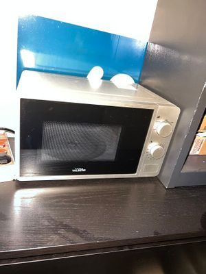 a microwave that is sitting on a table in a room