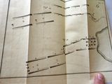 a person holding a book with a map on it