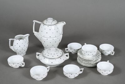 a white and black tea set with cups and saucers
