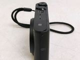 a black camera with a cord attached to it