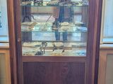 someone is taking a picture of a display case in a room