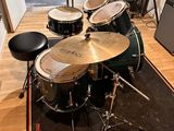 a drum set that is sitting on a rug in a room