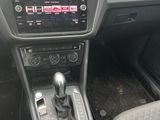 the interior of a car with a steering control and dashboard controls