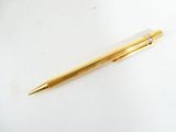 a pen that is laying on a white surface