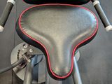 a black and red seat on a stationary exercise bike