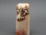 a close up of a small carved object on a table