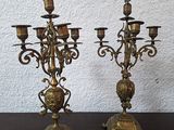 pair of antique brass candelabs on a wooden table