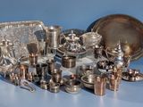 a lot of silverware on a table with a blue background