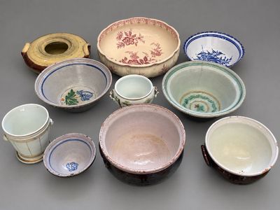 many different types of bowls and cups on the table