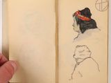 someone is holding a book with a drawing of a woman ' s head in it