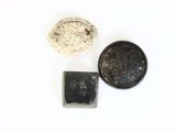two coins and a rock on a white surface