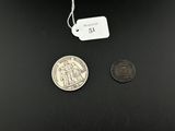 an image of a coin and a small coin on a black surface