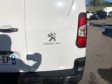 a white van parked in a parking lot with a person taking a picture