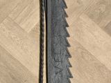 a large metal blade that is on a wooden floor