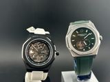 two watches that are on display on a stand