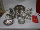 a table with a lot of silver items on it