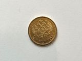an image of a gold coin sitting on top of a white surface