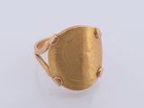 a close up of a gold ring on a white surface
