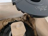 a black object in a brown bag with a wooden handle