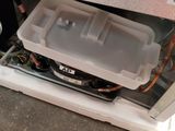 a white refrigerator with a plastic container on top of it