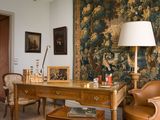 an image of a living room with a large tapestry on the wall