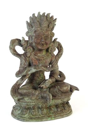 bronze statue of a woman sitting on a rock holding a snake