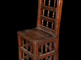 an old wooden chair with a wooden seat on a black background