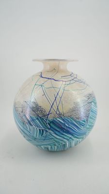 a glass vase with a blue and white design on it