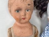 two dolls that are sitting next to each other