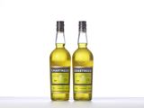 two bottles of chartreuse lemon liqueur on a white surface