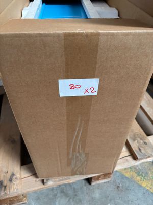 a cardboard box with a label on it sitting on a pallet