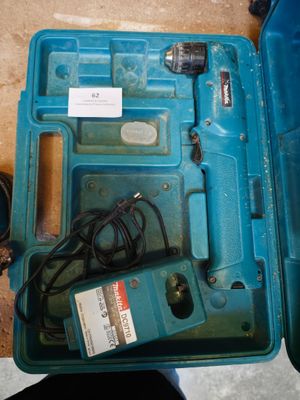a blue box with a drill and a cord in it