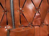 an image of a leather vest with a zipper on it