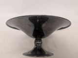 an image of a black glass bowl sitting on top of a table