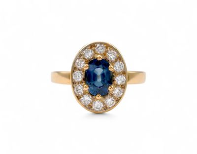 an oval sapphire and diamond ring in yellow gold