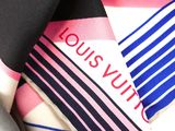 a close up of a neck tie with a louis vuitto logo