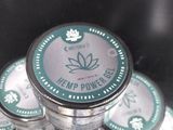 several tins of hemp powder sitting on top of each other