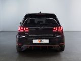 the rear end of a black volkswagen vw golf