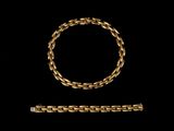 a gold bracelet and a gold bracelet on a black background