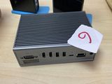 a small computer sitting on top of a wooden table