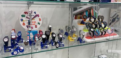 a glass display case with many different watches on it