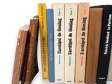 a lot of books that are stacked on a shelf