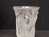 a glass vase with a design on it on a black surface