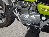 a green and black motorcycle parked in a parking lot