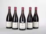 quatre bouteilles de vin sont alignées sur une table