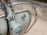 a close up of a motor bike with a bird on it