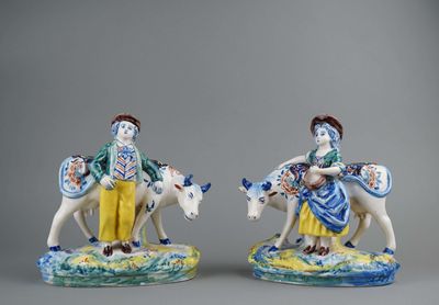 two figurines of a man and a woman riding on horses