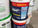 several buckets of paint sitting on top of a wooden pallet