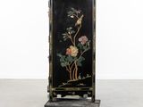 an antique black painted cabinet with flowers and birds on it